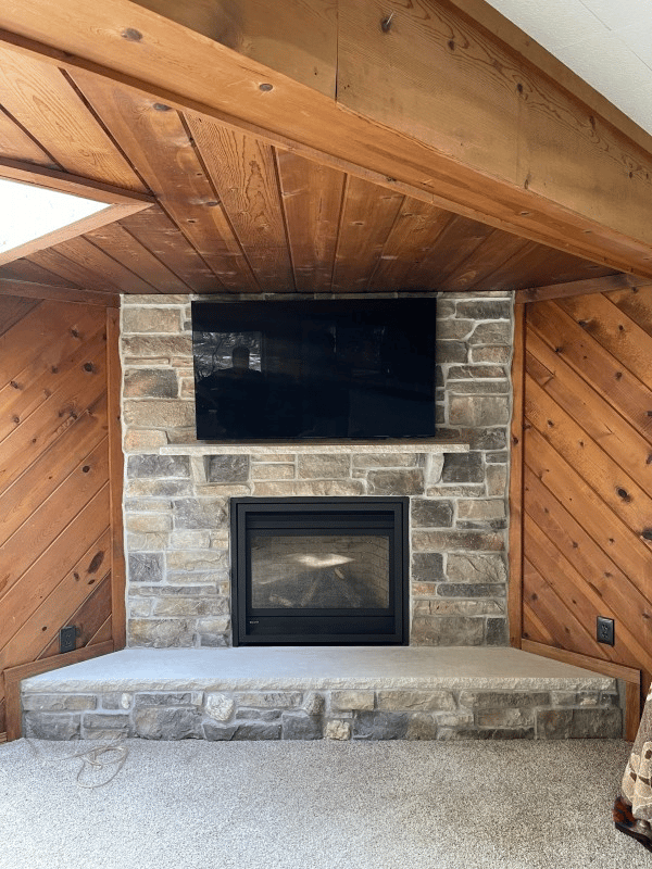 A modern Regency Panorama gas fireplace insert installed in a refreshed surround after renovation