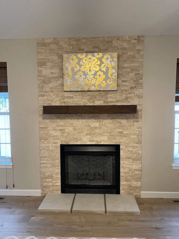 A clean, restored fireplace with a polished surround and tidy firebox after professional chimney servicing
